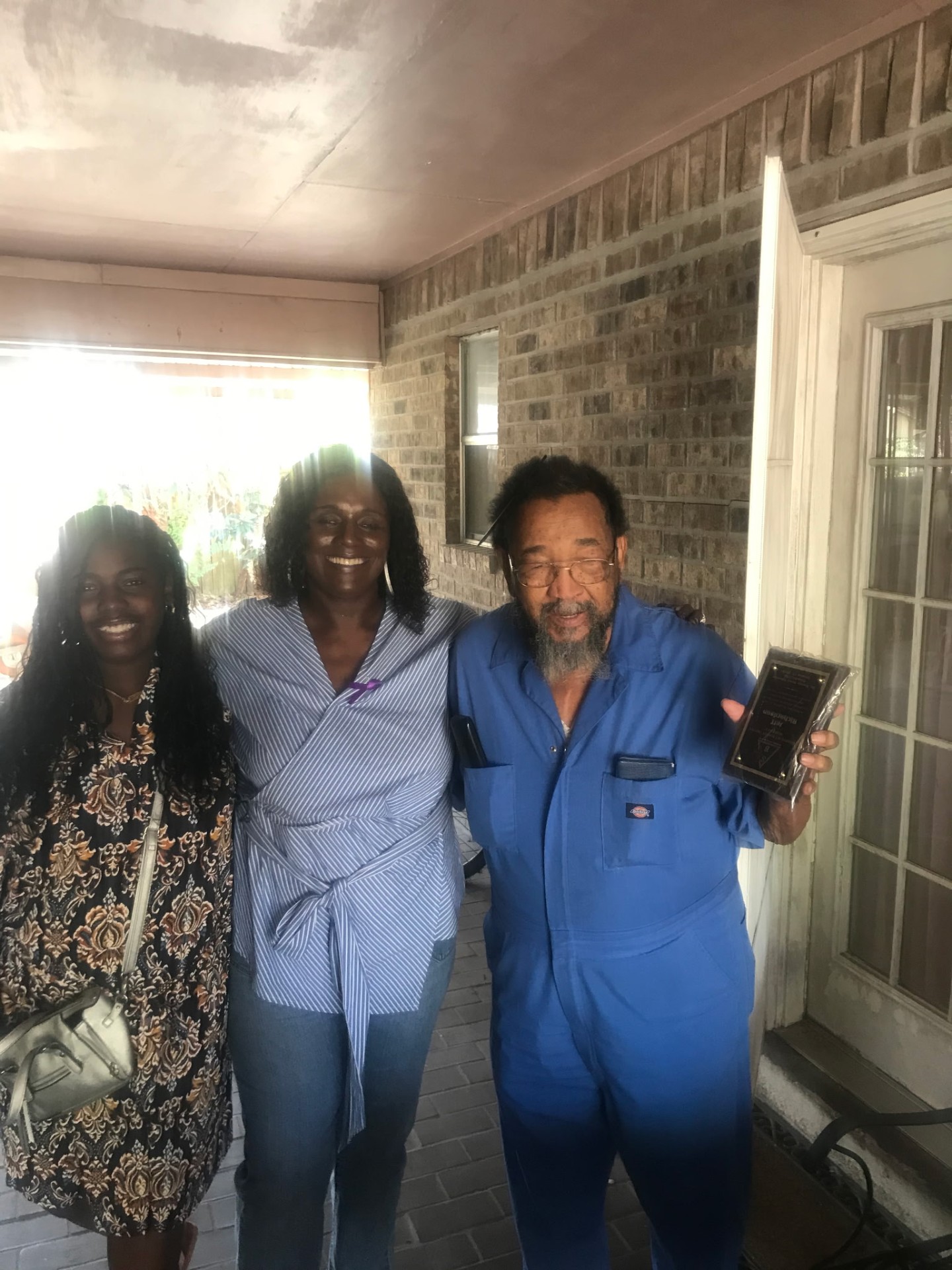 Delivering an award plaque to a neighbor